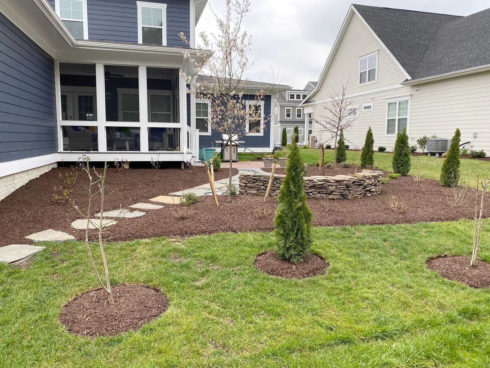 A house with a screened-in porch and a lush green lawn in front of it